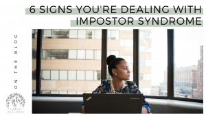 Graphic that reads "6 Signs You're Dealing With Impostor Syndrome" above a photo of a woman in front of a computer. she's sitting in front of windows and looking to her left.