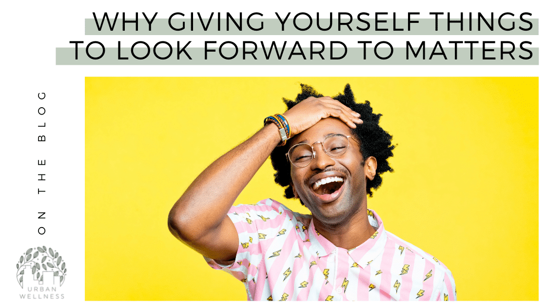 A graphic that reads "Why Giving Yourself Things To Look Forward To Matters" in black text over a light green background, above a stock photo of an excited looking Black man with his hand in his hair in front of a bright yellow background.